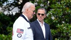 President Joe Biden, wearing a Team USA jacket and walking with his son Hunter Biden, heads toward Marine One on the South Lawn of the White House in Washington, July 26, 2024. (AP)