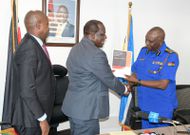 CS Oparanya when he handed the forensic report on KUSCCO to IG Douglas Kanja