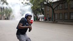 Larry Madowo reacts after being hit by a teargas fragment while covering protests in Nairobi