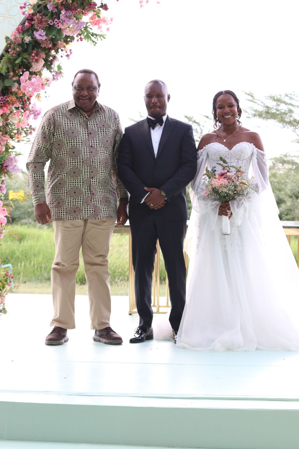 Retired President Uhuru Kenyatta with newlyweds, James Kimoi and his wife Ivy