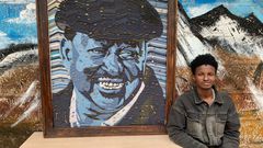 George Njenga, also known as Tetra G, alongside his artpiece of the late former Prime Minister Raila Odinga