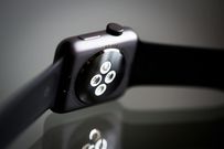 The underside of a smartwatch with sensors showing