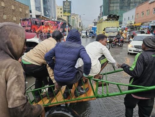 File image of Nairobi residents using a handcart to cross a flooded section of the road (Courtesy)