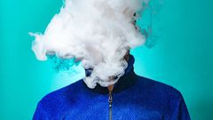 A person with a cloud of smoke on their face