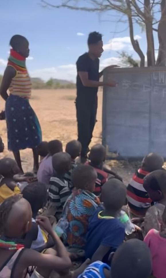 A screen-grab image of Eric Omondi with the children in Turkana who endure difficult conditions to learn