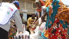 A USAID staffer assisting women