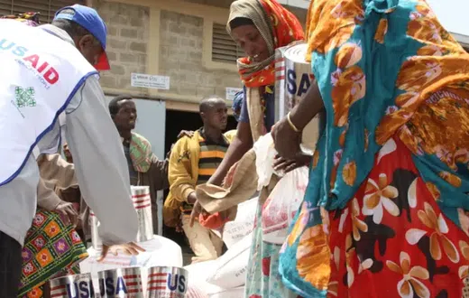 A USAID staffer assisting women