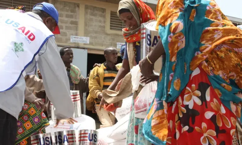 A USAID staffer assisting women