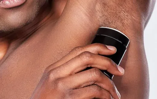 A man using deodorant