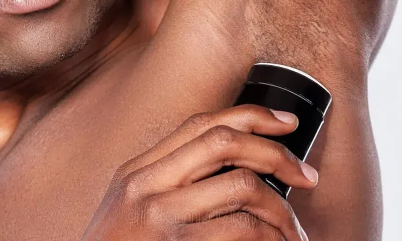 A man using deodorant