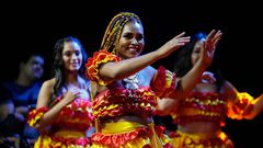 Members of the Paraguay-African cultural group Kamba Cua dance during celebrations in honor of Saint Balthazar, one of the Three Kings, on Epiphany in Fernando de la Mora, Paraguay, just after midnight Sunday, Jan. 9, 2022.