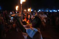 Members of the Paraguay-African cultural group Kamba Cua dance during celebrations in honor of Saint Balthazar, one of the Three Kings, on Epiphany in Fernando de la Mora, Paraguay, just after midnight Sunday, January 9, 2022.