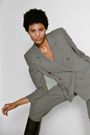 A model in a two-piece Giorgio Armani 'greige' suit, a mix of grey and beige