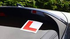 A car with a learner sticker