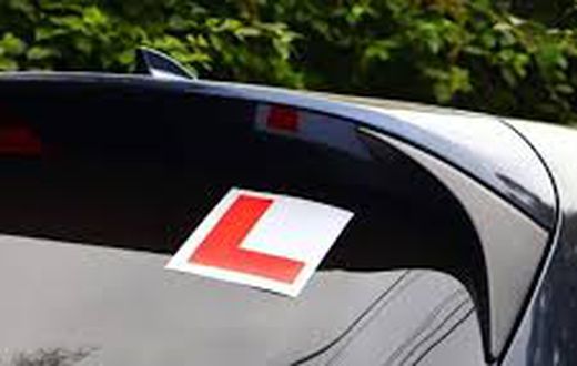 A car with a learner sticker