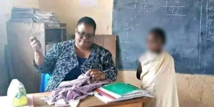 File image of teacher Joyce Sempela Malit mending a student's uniform inside a classroom