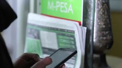 A person using MPESA to pay for services