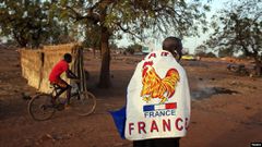A man wears a French flag to show support for the French military intervention in Mali, in the capital, Bamako, Jan. 14, 2013.