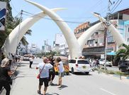 File image of tourists posing for photos at the iconic artificial elephant tusks located along Moi Avenue in Mombasa