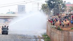 Police using a water canon against protestors along Waiyakia Way