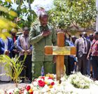 Kalonzo Musyoka standing next to Raila Odinga's grave