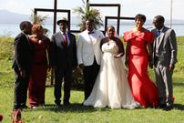 Damarie Saada and Martin Nyaga pose for a photo with guests and family on their wedding day
