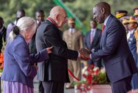 Mathare Youth Sports Association founder Bob Munro being conferred with the Elder of the Order of the Burning Spear (EBS) by President William Ruto