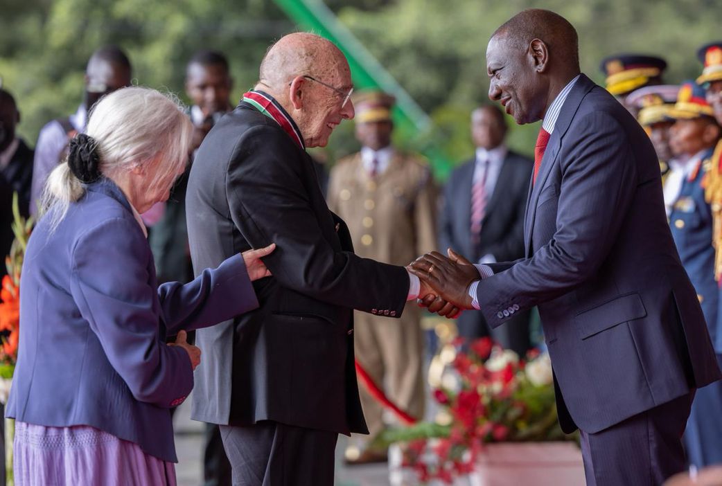 Mathare Youth Sports Association founder Bob Munro being conferred with the Elder of the Order of the Burning Spear (EBS) by President William Ruto