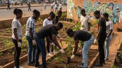 An AI-generated image of young people planting trees