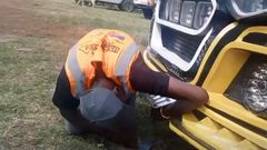 An inspection officer removing the number plates from Money Fest matatu