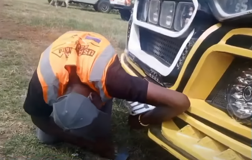 An inspection officer removing the number plates from Money Fest matatu