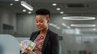 An AI-generated image of a lady holding banknotes