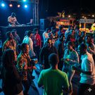 An AI-generated photo of people enjoying music in an event