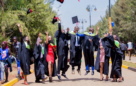 Graduates throwing their hats in the air to celebrate