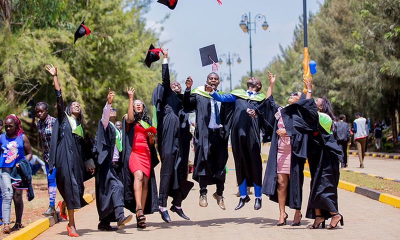 Graduates throwing their hats in the air to celebrate