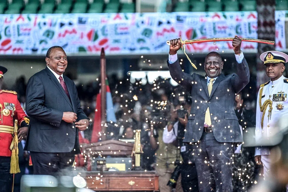 Former President Uhuru Kenyatta handing over the instruments of power to President William Ruto