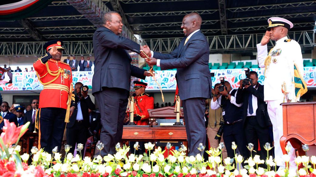 Former President Uhuru Kenyatta handing over the instruments of power to President William Ruto