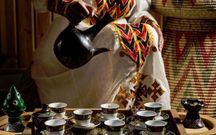 Freshly roasted coffee beans are ground, brewed, and served in three rounds