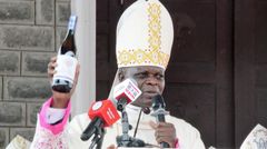 Archbishop Maurice Muhatia Makumba holding Mass Wine that will be used by the Catholic Church in Kenya going forward