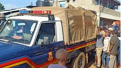 File image of a police vehicle surrounded by members of the public