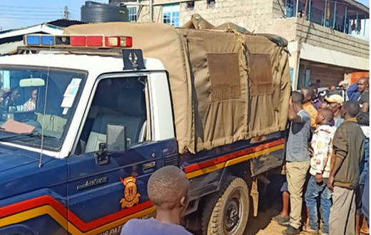 File image of a police vehicle surrounded by members of the public