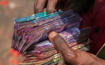 A person holding a wad of cash