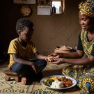 An image of a mum serving her child food