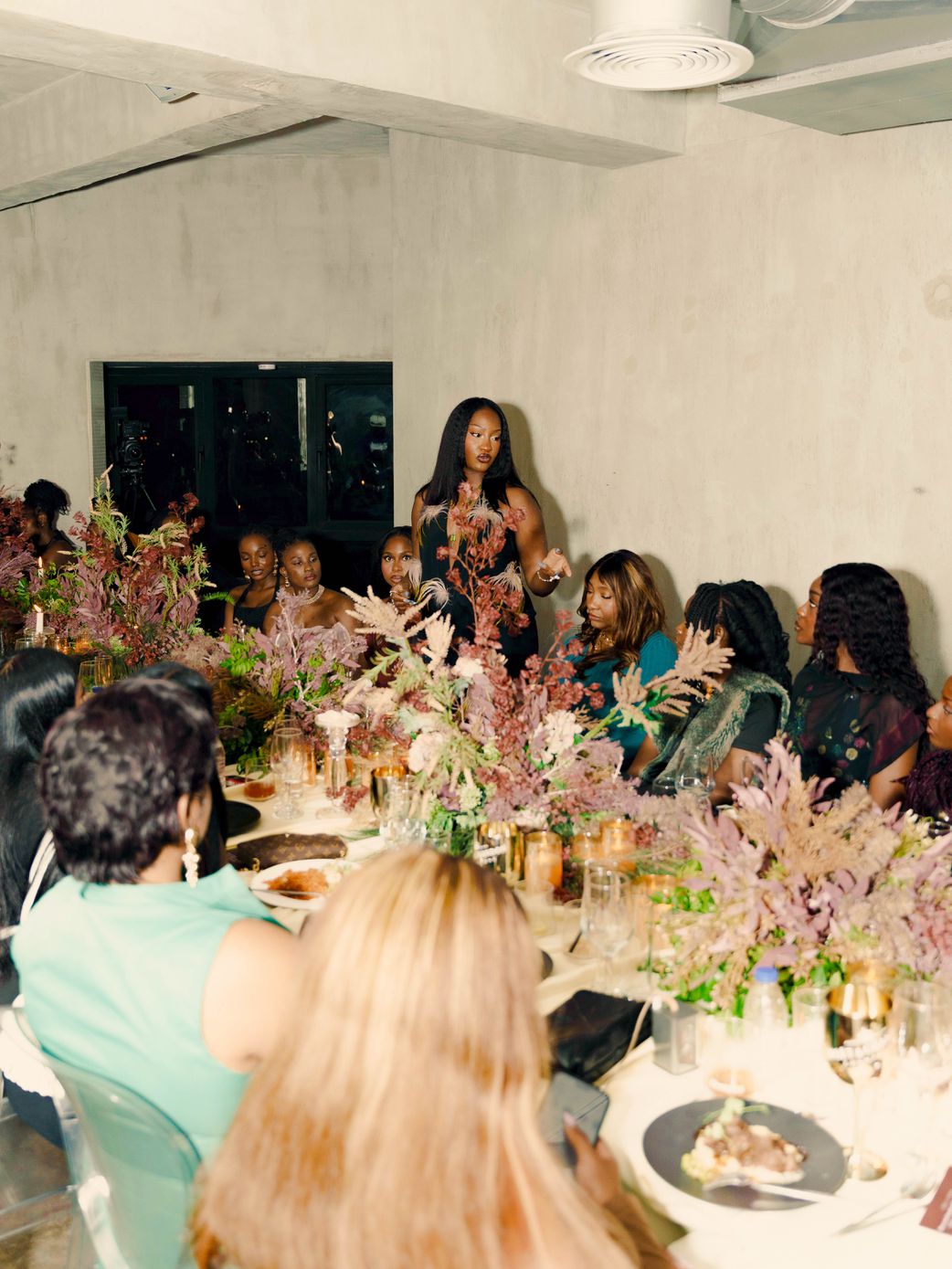 Tems gives welcome remarks at the dinner