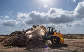 A member of the 475th Civil Engineer Flight at Camp Simba, Manda Bay, Kenya, operates a front loader