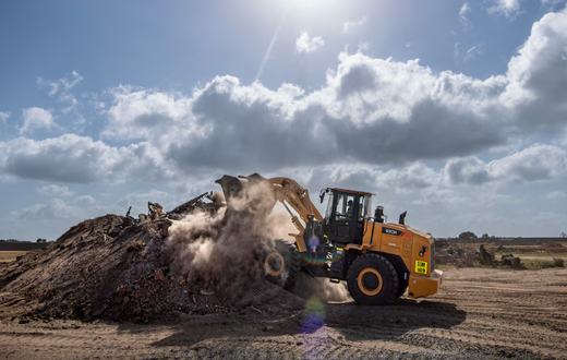 A member of the 475th Civil Engineer Flight at Camp Simba, Manda Bay, Kenya, operates a front loader