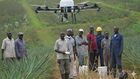Farmers using a drone in the field