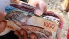 A person holding a wad of cash