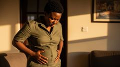 A bloated woman looking at her tummy
