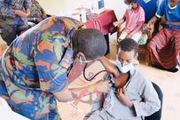 A Kenya Defence Forces doctor performs a checkup on a patient